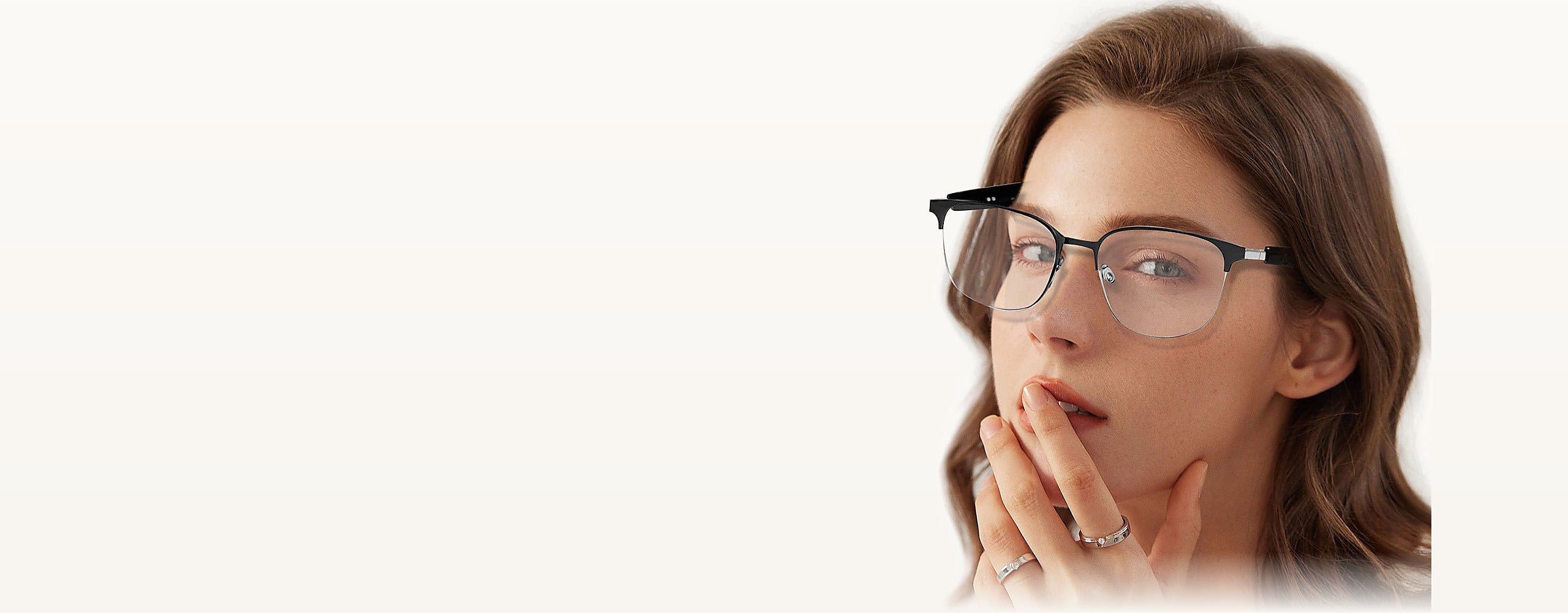 Woman wearing SparkGlas photochromic audio glasses, clear lenses indoors